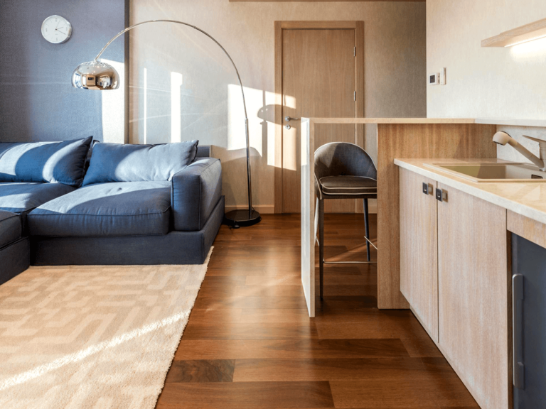 Cozy small living space featuring a compact kitchen with wooden