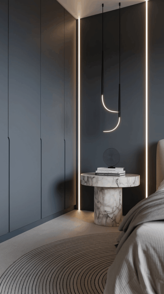 Classy bedroom corner featuring a round marble bedside table with books and geometric decor, set against dark blue walls and illuminated by striking pendant lights.