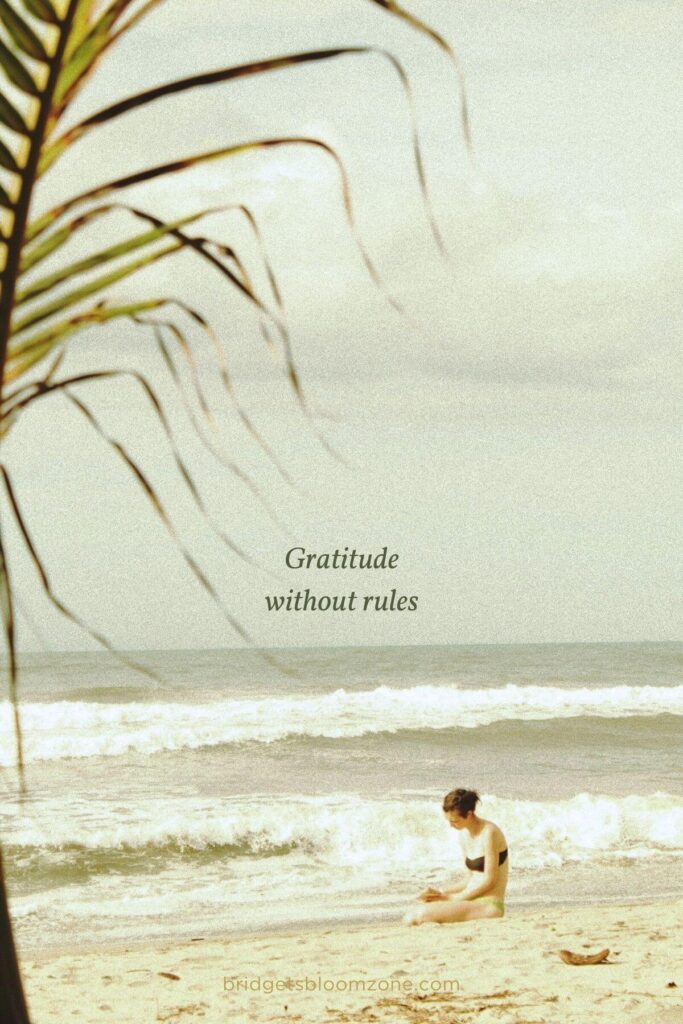 A person sits quietly on the beach near the ocean, focused and relaxed, illustrating the importance of personal reflection in building habits for a healthy life.
