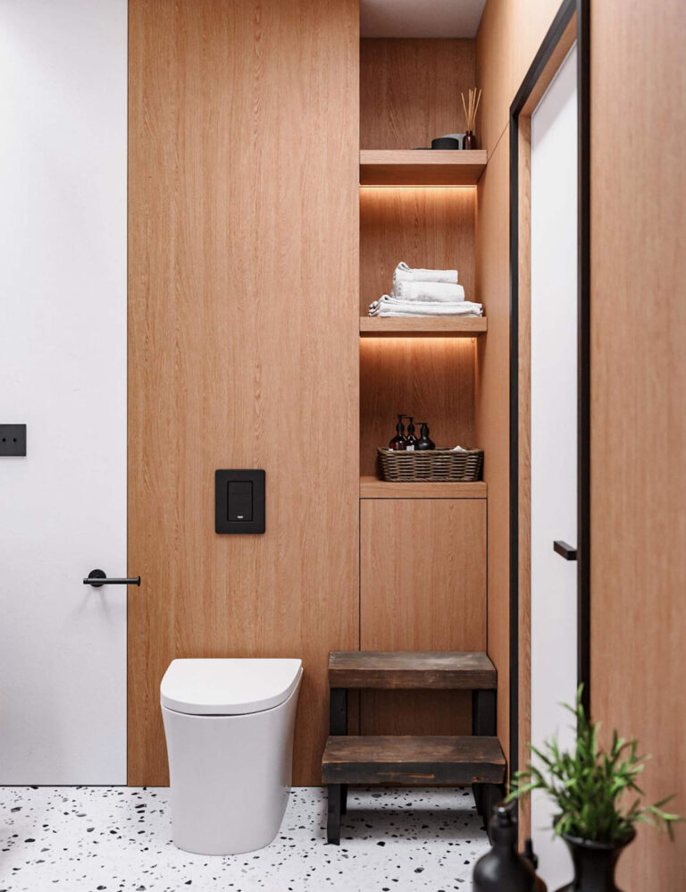 Contemporary bathroom with wooden cabinetry featuring built-in open shelves above the toilet, storing towels and a basket.
