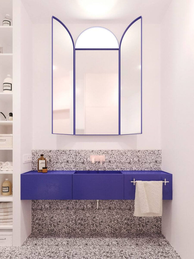 Bright cobalt blue vanity and terrazzo textures make this bathroom pop with bold small bathroom color ideas, adding vibrance to modern bathroom color palettes and inspiration.