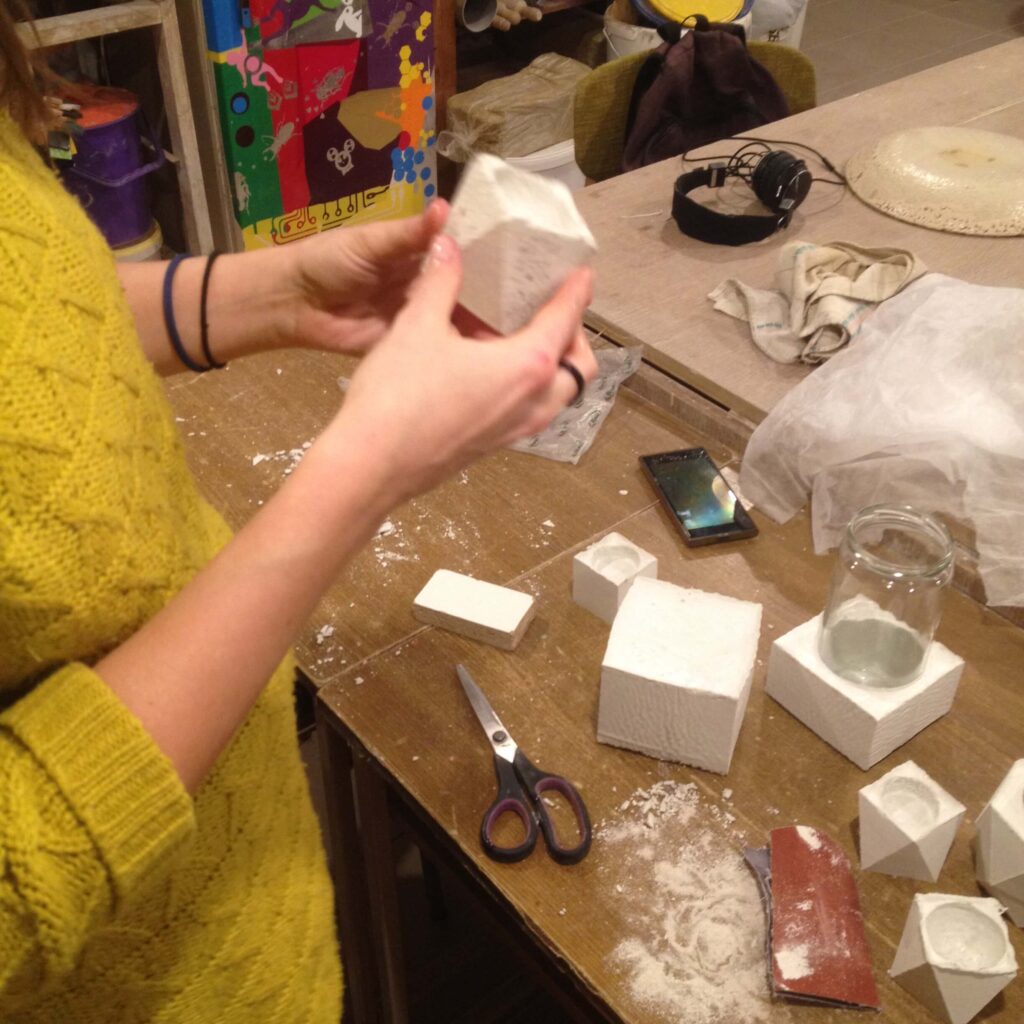 White Cement Diy Craft project with a person sanding a geometric white cement container as a simple diy gift for friends.