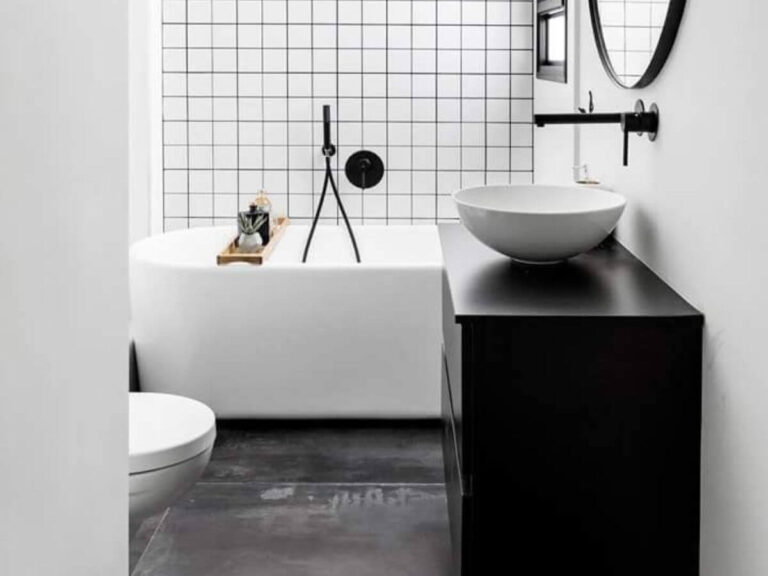 Black and white tiny bathroom with a classic bathroom tile combination: white square tiles on tha wall, grey stone like large tiles on the floor, connected by black grout color and black vanity. Elegant example for a modern small bathroom.