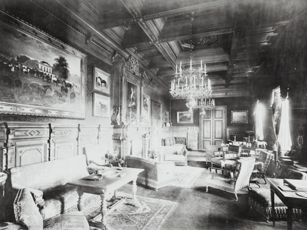 A black and white photo of a drawing room or gentlemen's room from Hungary, castle Festetics. Large space, elegant and rich furniture, we can feel luxury and gold.