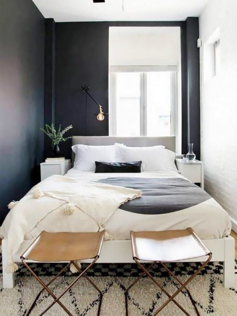 Narrow small bedroom with bed against the window and clear floor space on the access side