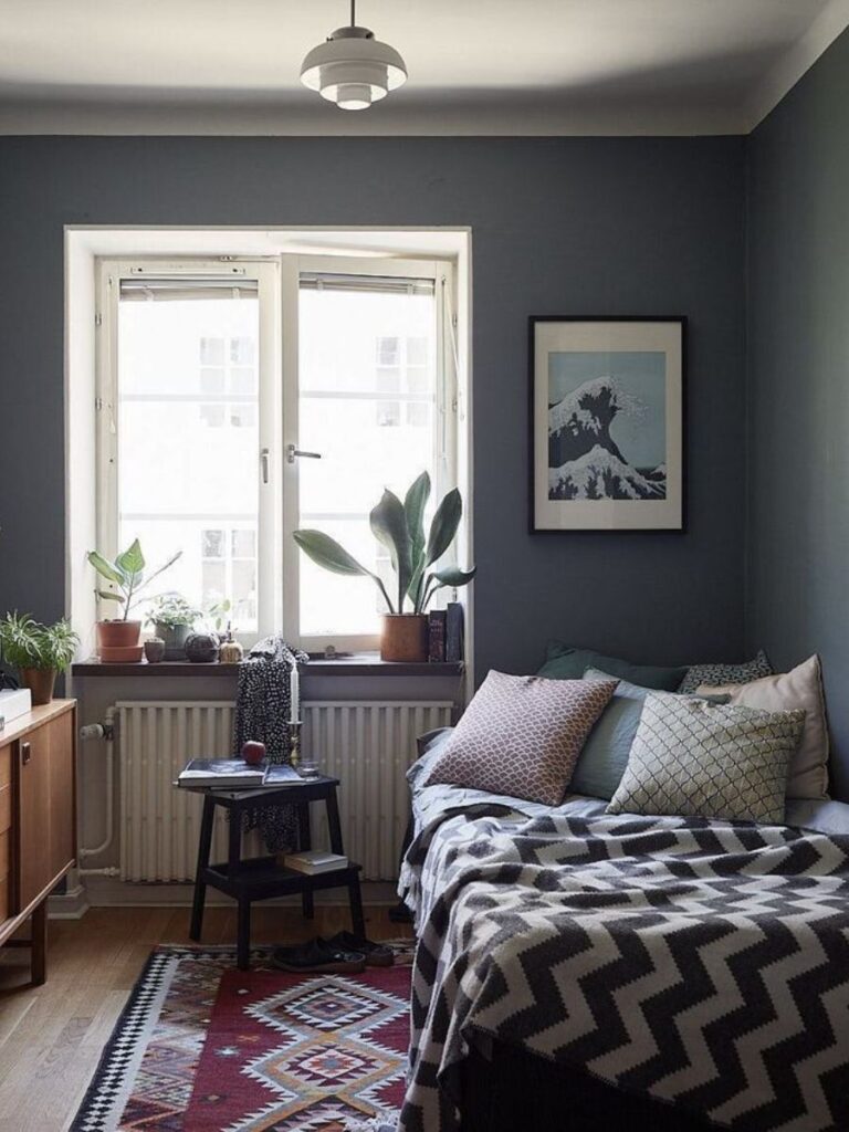 Narrow small bedroom with bed against the wall and clear floor space on the access side